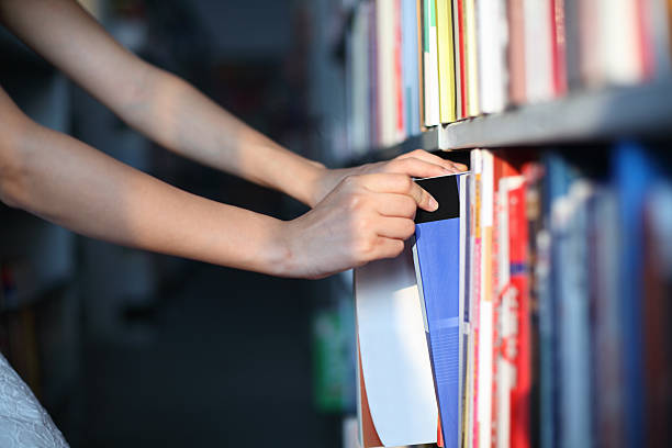 istock Girl Picking Books in Library 186771898