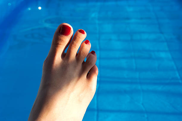 istock Feet up, relaxing by the pool 186771996