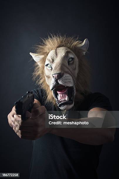Robber In Lion Mask Stock Photo - Download Image Now - Adult, Aiming, Anger