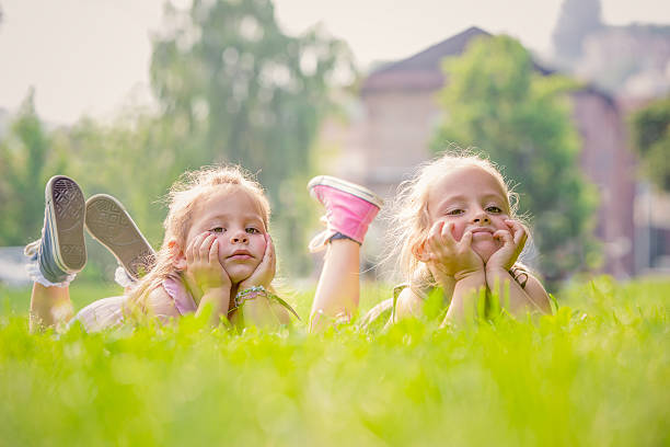 istock Blonde sisters having fun at park 186772355