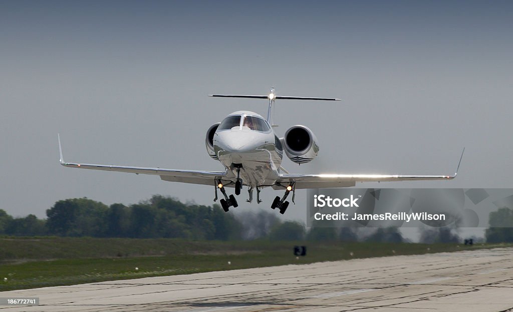 Lear Jet 60 Departure Lear Jet model 60 lifts off the runway, landing gear retracting. Air Vehicle Stock Photo