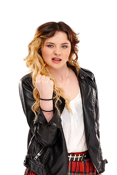 Angry young girl ready for fight Portrait of angry young female showing her fist to you against white background punching one person shaking fist fist stock pictures, royalty-free photos & images