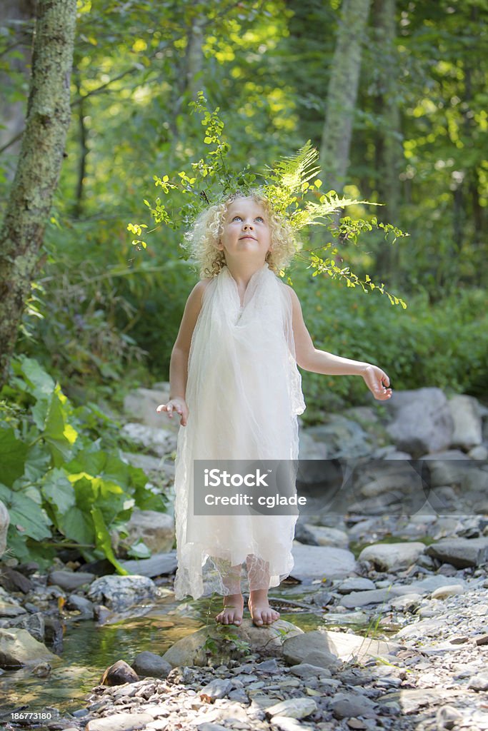 Woodland Fairy Looking up Adorable, five year old girl playing fairy in a stream Beautiful People Stock Photo