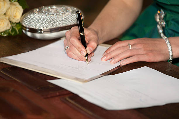 woman hands sign up marriage certificate married to sign marriage certificate ring tilt stock pictures, royalty-free photos & images