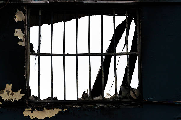 istock Closeup fire damaged window with safety bars 186773766