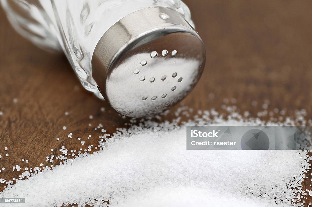 Salt shaker with metal lid Salt shaker with metal lid and salt Condiment Stock Photo