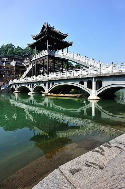 woodens houses and bridge with toujiang river in fenghuang ancient town,china