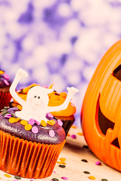 istock Little Ghost Halloween Cupcake and Giant Pumpkin 186774221
