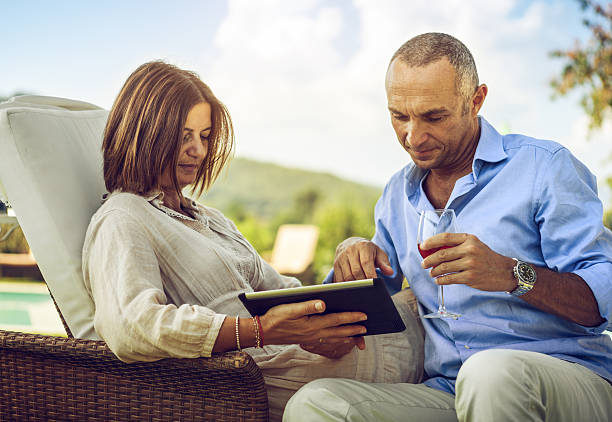 istock Mature couple planning vacation on laptop 186774697