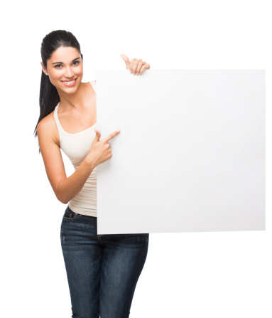 Happy woman pointing at a blank sign