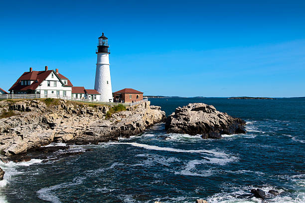 portland head light, felsen, meer surfen in den morgen. blauen himmel. - portland maine stock-fotos und bilder