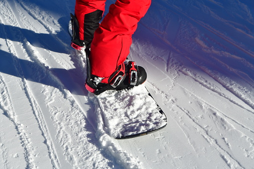 Snowboarder on the slopes showing his legs