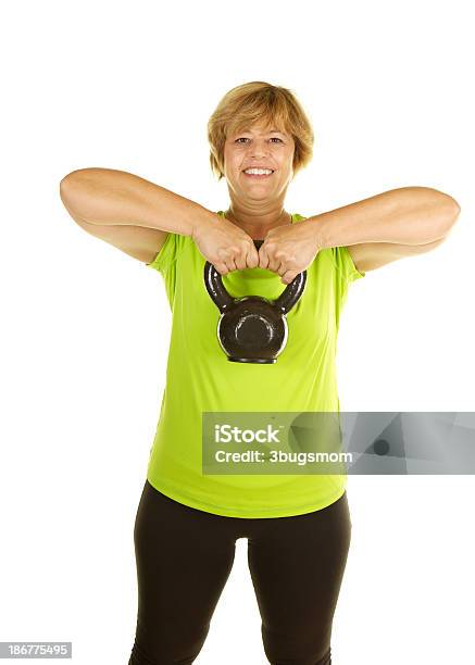 Mature Woman Lifting Weights With A Kettle Bell On White Stock Photo - Download Image Now