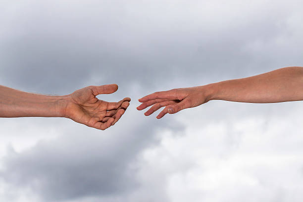 istock Male and female hands reaches out to help, copy space 186775536