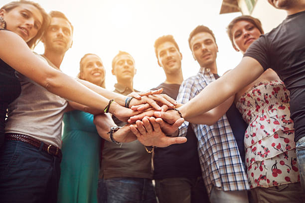 istock Group of friends pile up hands as unity oath 186776327