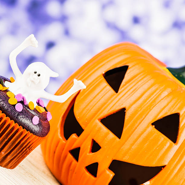 istock Little Ghost Halloween Cupcake and Giant Pumpkin 186776340