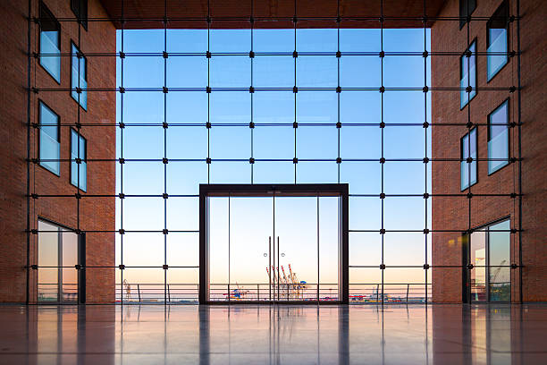 Hamburg harbor through a glass facade of a modern office building.