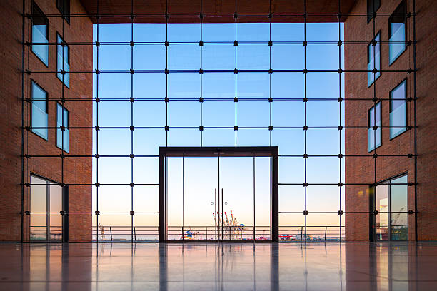 Modern office, Hamburg harbor in a square Hamburg harbor through a glass facade of a modern office building. hamburg germany photos stock pictures, royalty-free photos & images