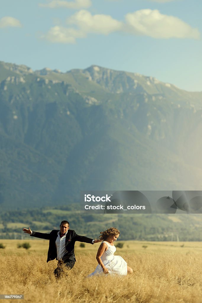 joyful wedding couple happy and funny wedding couple in wheat field. 25-29 Years Stock Photo