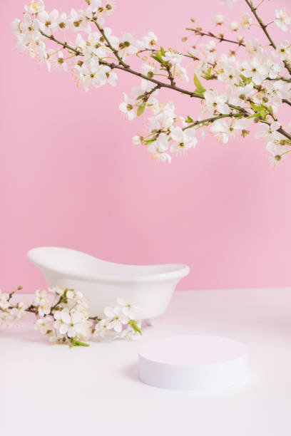 istock Empty podium or pedestal with spring bloom and bath. Spring mock up for cosmetic products 1867795507