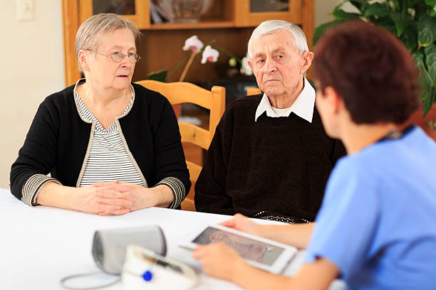 istock Female nurse and elderly couple 186780235