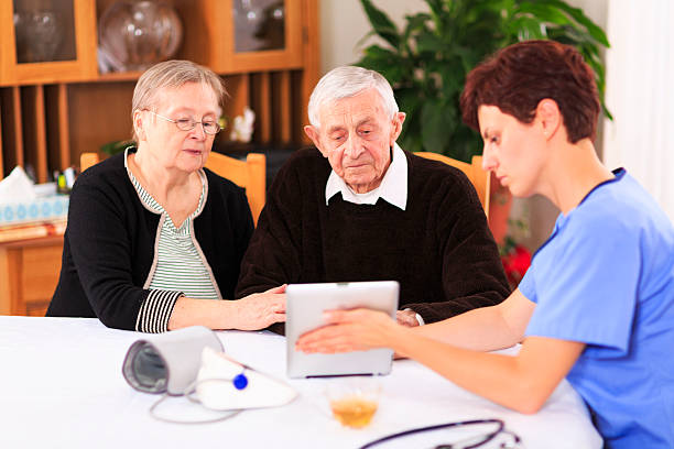istock Female nurse and elderly couple 186780237