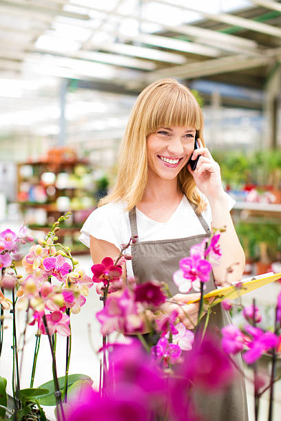 istock Female Florist Working At Garden Center. 186780280