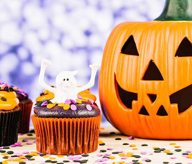 istock Little Ghost Halloween Cupcake and Giant Pumpkin 186780586