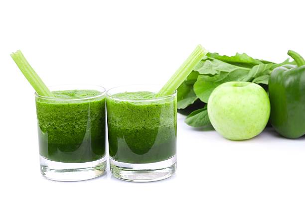istock Green juice and Vegetable variety isolated on white background 186781326