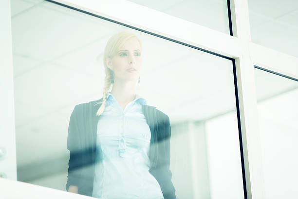 istock businesswoman looking through window 186786155