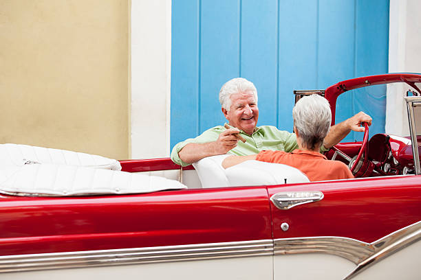 istock Happy couple driving a cuban classic car 186789673