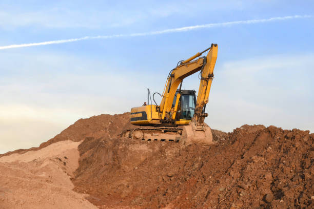 istock Excavator on earthmoving. Open pit mining. Backhoe dig ground in quarry. Heavy construction equipment on excavation on construction site. Excavator on groundwork foundation. Excavation contractors 1867927323