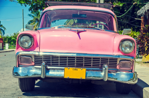 An old American car in Cuba with a vintage filter.