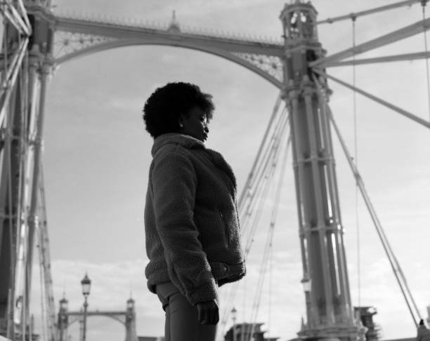 istock Alternative black woman standing on historical bridge structure. 1867934547
