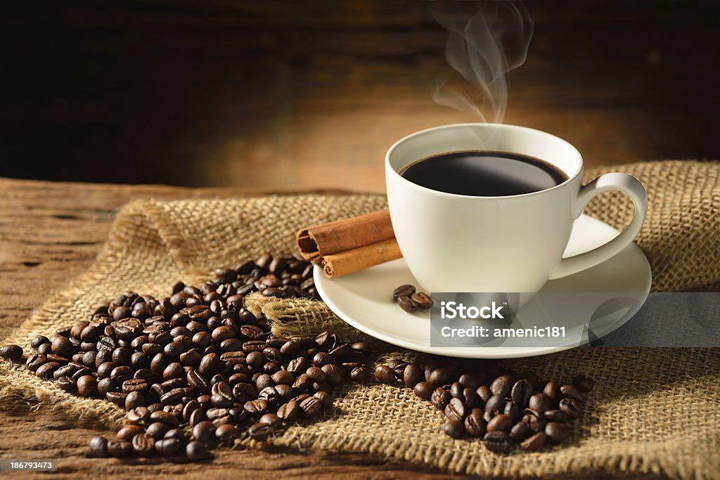 Coffee Coffee cup and coffee beans on old wooden background. Backgrounds Stock Photo