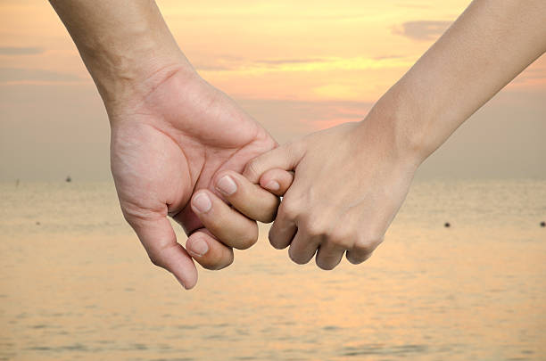 istock couple holding hands on sunset 186793715