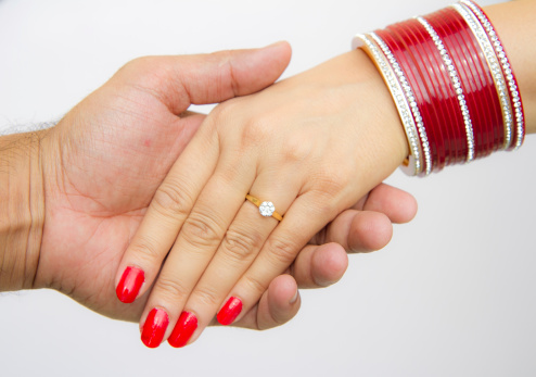 Indian married man woman holding hands
