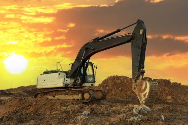 istock Excavator on earthmoving in open pit mining. Backhoe dig ground in quarry on sunset. 1867939309