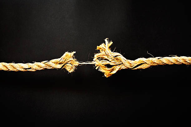 istock Extreme stress symbolized by rope frayed to final strand 186794227
