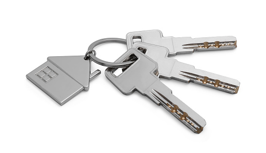 Keys with keychain in shape of house isolated on white