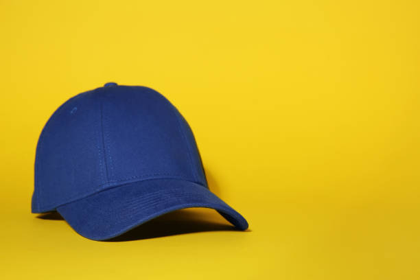 istock Stylish blue baseball cap on yellow background, space for text 1867959443