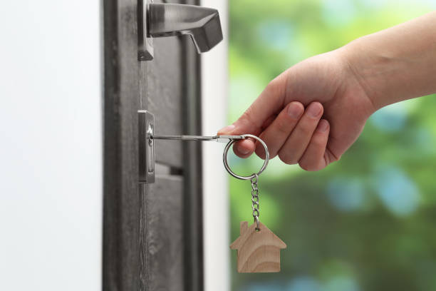 istock Woman unlocking door with key outdoors, closeup 1867960524