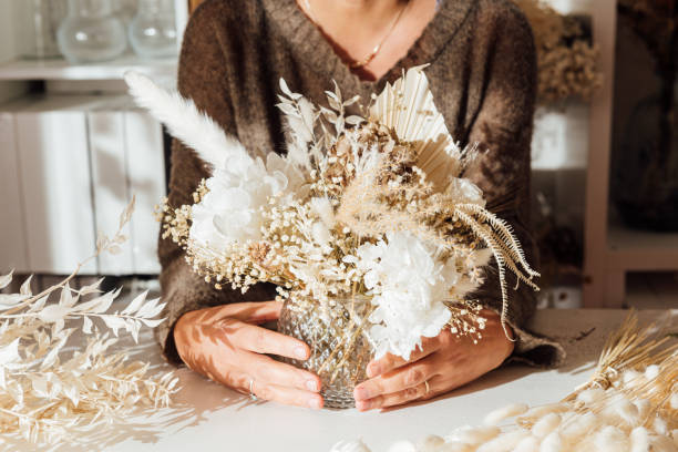 istock Faceless specialist with creative composition of withered flowers 1867965342