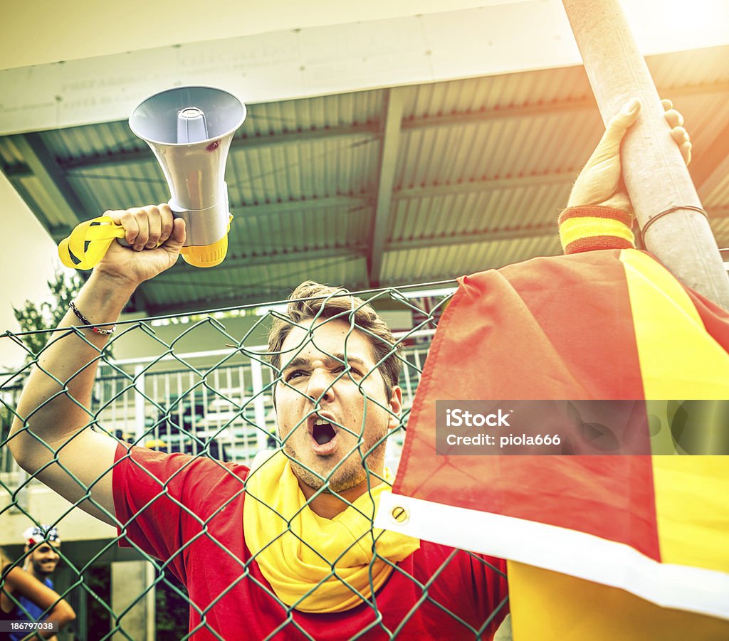 Angry team supporter by the fence of a stadium Adult Stock Photo