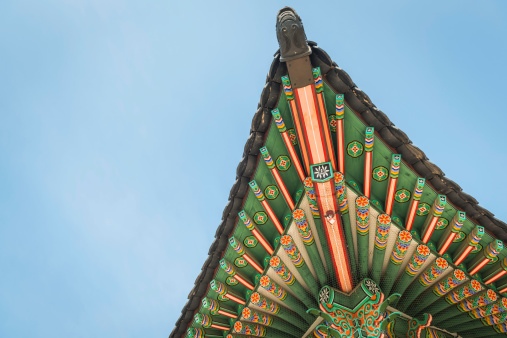 The vibrant colours of traditionally painted wooden beams and curving pagoda eaves of a pavilion in Gyeongbokgung, Seoul, South Korea. ProPhoto RGB profile for maximum color fidelity and gamut.
