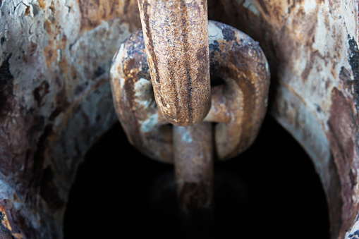 Rusty anchor chain on a ship close-up.