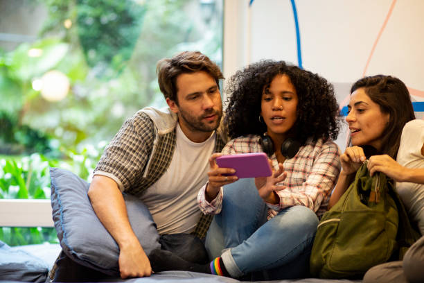 istock Group of friends taking a selfie with smartphone while lying on couch 1867984591
