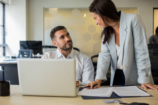 istock Business people discussing work over paper work and laptop 1867986185