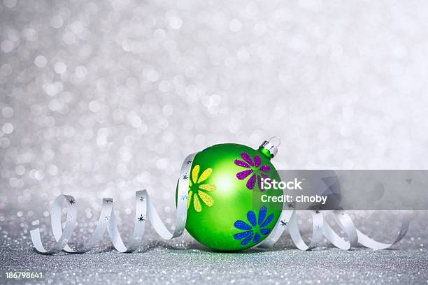 Christmas Bauble With Curling Ribbon On Glitter Background Stock Photo - Download Image Now