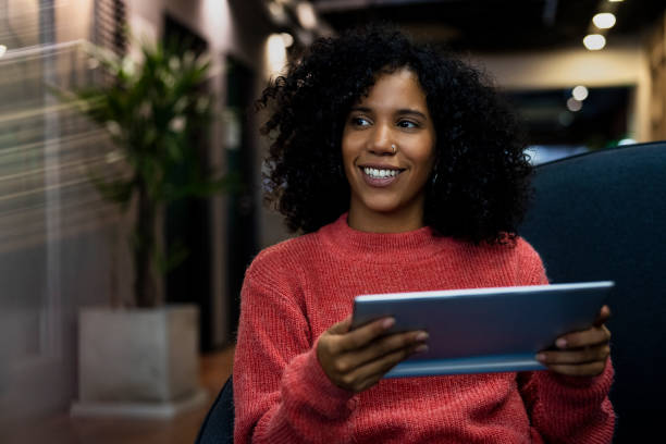 istock African American office worker using digital tablet while sitting on chair 1867987339